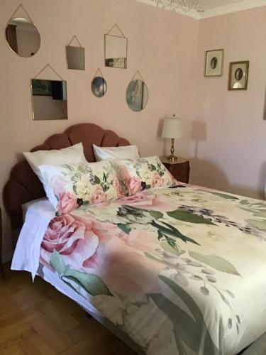 a bedroom with a bed with flowers on it at La Gaillarde in Céreste