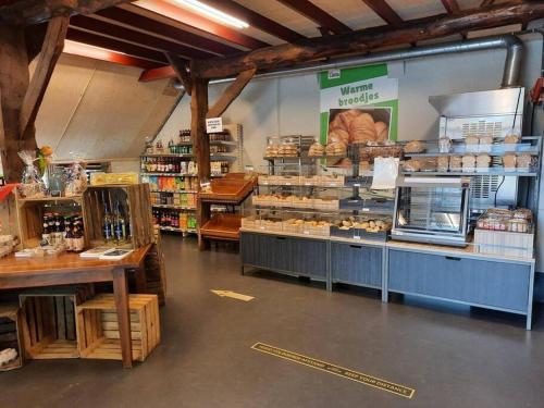 a store with a bakery with a lot of food at Chalet vakantiepark Kleine Belties 18 in Hardenberg