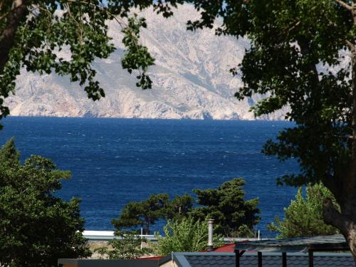 a view of the ocean with mountains in the background at Mobile Homes "Golden Stone" in Sveti Juraj