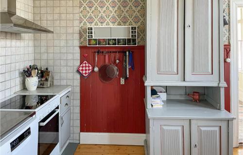 a kitchen with a red door in the corner at Gorgeous Home In Lindesberg in Lindesberg