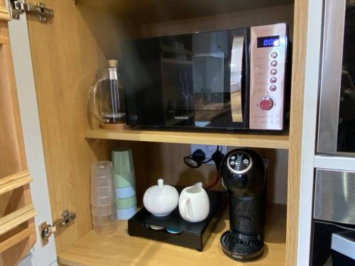 a microwave and a coffee maker in a kitchen at Farm Stay at THE GLEBE COTTAGE KILREA in Tamlaght