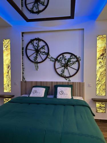 a bedroom with two clocks on the wall and a bed at Grenoble LA SUITE 2 spa jaccuzzi et sauna privatif in Grenoble