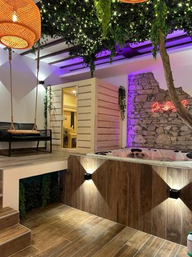 a bar in a room with a stone wall at Grenoble LA SUITE 2 spa jaccuzzi et sauna privatif in Grenoble
