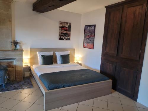 a bedroom with a bed in a room with a fireplace at Chez Catharina Oldtimer B&B in Levoncourt