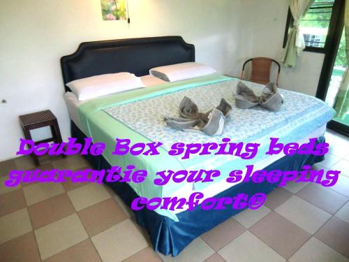 a bedroom with a bed with shoes on it at Residence House in Trat
