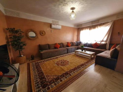 a living room with a couch and a rug at Jacaranda in Marrakesh