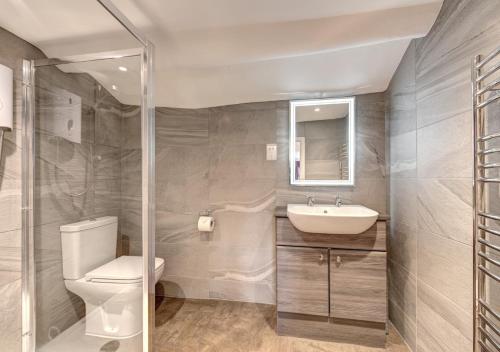 a bathroom with a toilet and a sink at Rose Cottage in Chapel Stile