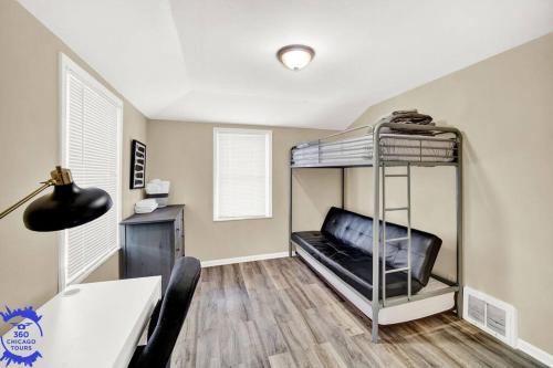 a room with a bunk bed with a desk at The Katerina Residence in Calumet City