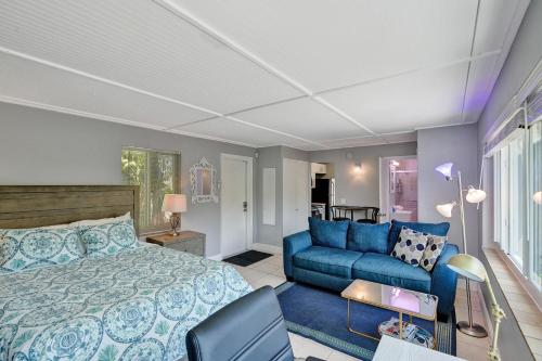 a bedroom with a bed and a blue couch at Oasis by Las Olas Lux Getaway in Fort Lauderdale