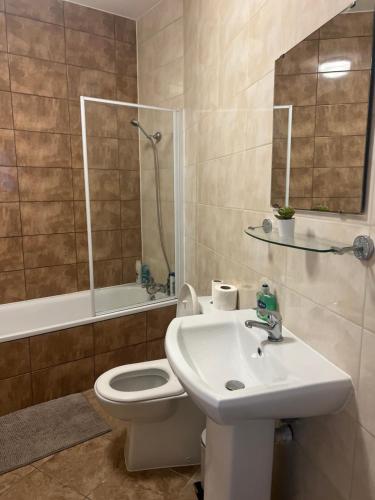 a bathroom with a sink and a toilet and a shower at 3 Bedroom Flat in Town Centre in Wellingborough