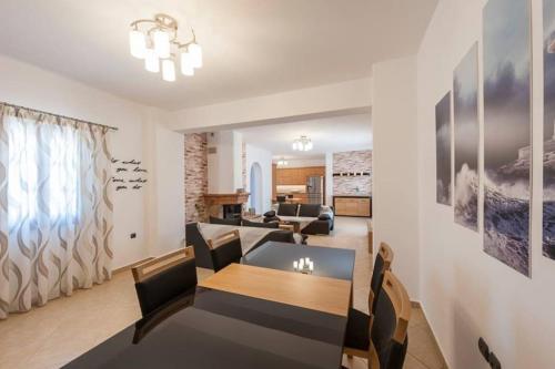a living room with a table and a dining room at Dream Inn Paros, private pool in Sarakíniko