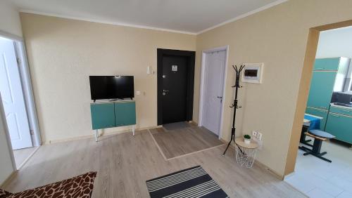 a living room with a flat screen tv on a wall at Pomiculturii Residence 4 in Timişoara