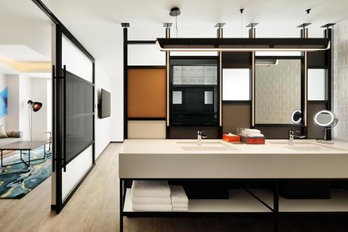 a bathroom with two sinks and a mirror at Aloft Osaka Dojima in Osaka