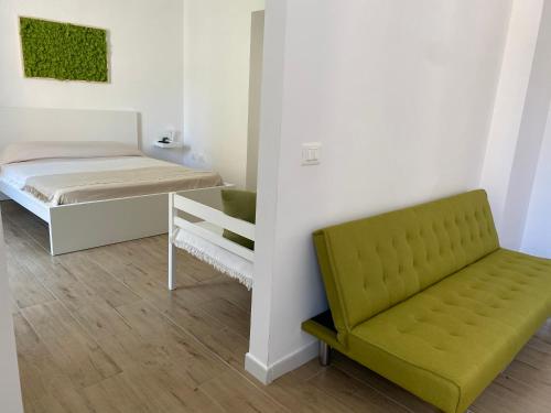 a room with a bed and a couch and a chair at Vanvitelli Apartments in Caserta