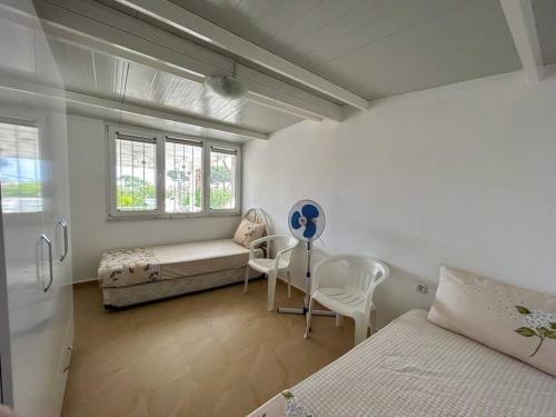 a bedroom with a bed and a couch and a table at Somos Flats - Mavişehir in Didim