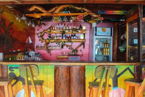 a colorful bar with two stools in front of it at Princesa del Mar in Playa Blanca