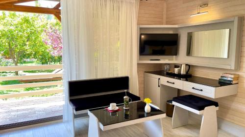 a room with a desk and a table and a window at Aida Hotel in Cıralı