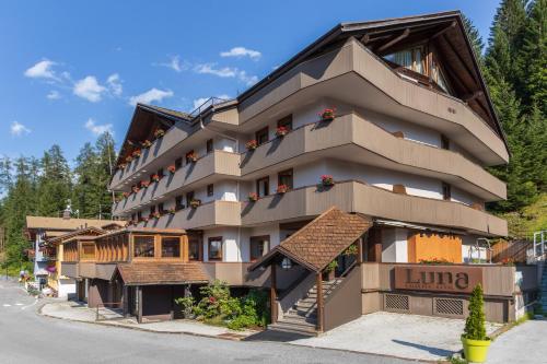 a building with balconies on the side of a street at Luna Wellness Hotel in Folgarida