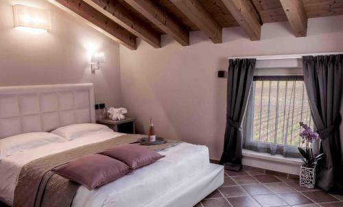 Un dormitorio con una cama grande y una ventana en Agriturismo Relais La Casina, en Cavriana