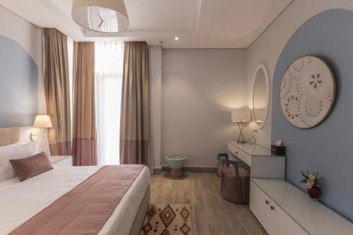 a hotel room with a bed and a mirror at Gewan Resort New Alamein in El Alamein