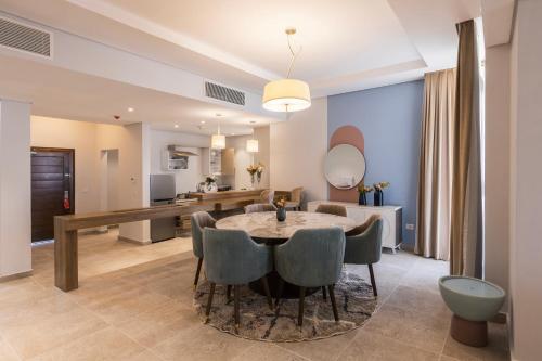 a dining room and living room with a table and chairs at Gewan Resort New Alamein in El Alamein