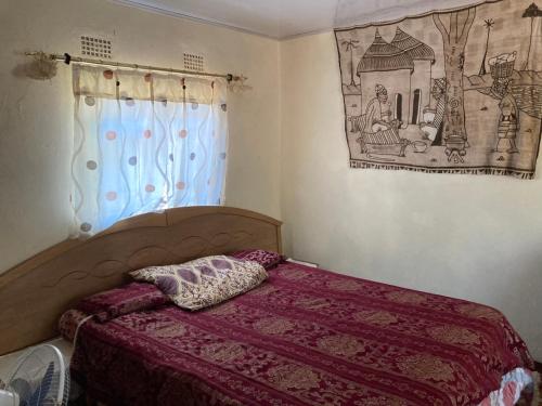 Llit o llits en una habitació de Nakawa Community Campsite