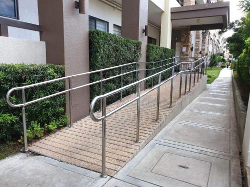 a metal hand rail next to a building at Davao 2br One Oasis Beside SM Mall-Wifi in Davao City
