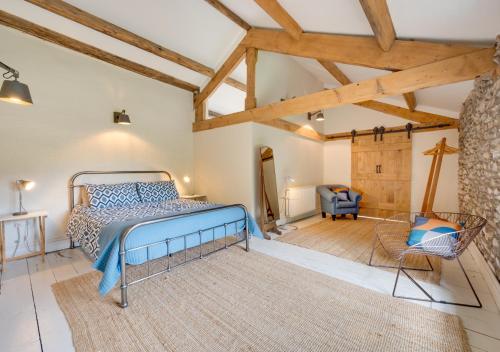 a bedroom with a bed in a room with wooden ceilings at Fell View in Silecroft