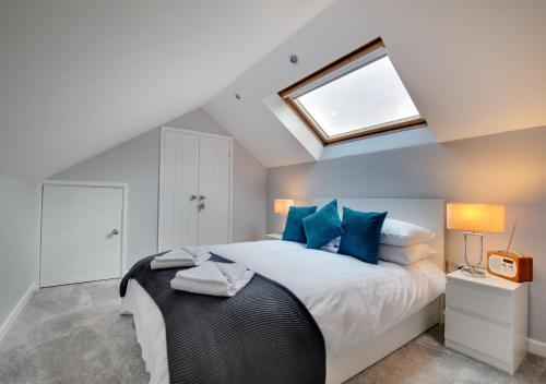 a bedroom with a large bed with blue pillows at Toffee Cottage in Chapel Stile