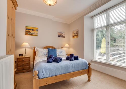 a bedroom with a bed and a window at Elterwater Apartment in Bowness-on-Windermere