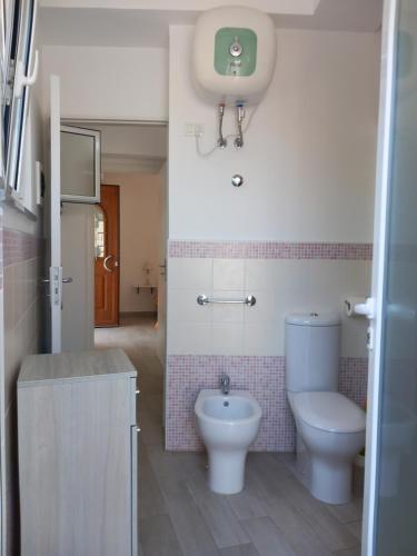 a bathroom with a toilet and a sink at Da Raff house in Lacco Ameno
