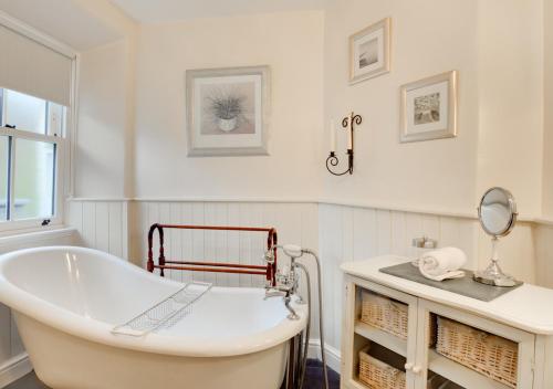 Baño blanco con bañera y lavamanos en Crag Head Cottage en Ambleside