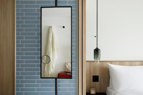 a mirror on a wall next to a bed at Fairfield by Marriott Mie Kumano Kodo Mihama in Mihama