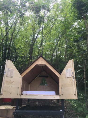 a large wooden dog house in the woods at StarsBox CasaSilvana in Alba
