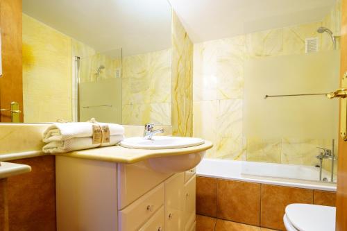 a bathroom with a sink and a toilet and a tub at HomeHolidaysRentals Bijou - Costa Barcelona in Pineda de Mar