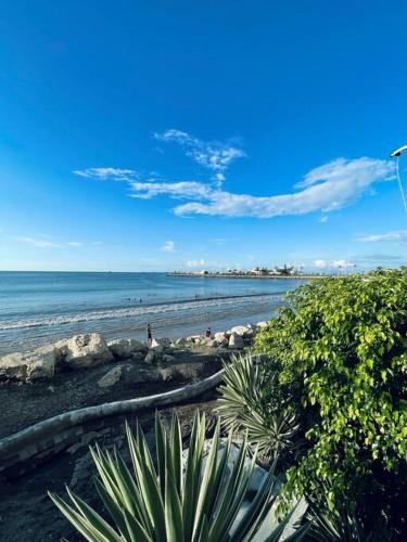 a beach with people on the sand and the water at Suite a pasos de la playa! in Salinas