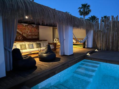 サン・ジョルディにあるVILLA SERENITY 3 Luxury boutique villaのベッドとスイミングプール付きのリゾートです。