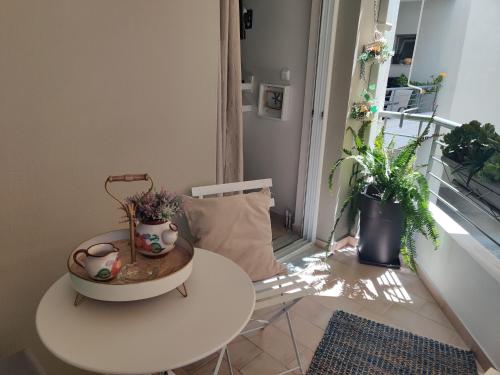 a room with a table and two potted plants at Boheme and Style in Preveza