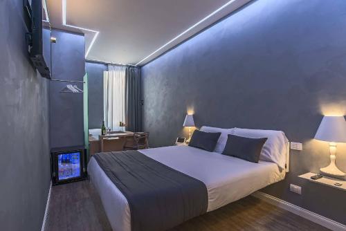 a bedroom with a large bed and a television at Ripetta Relais in Rome