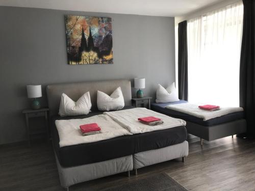 a bedroom with two beds with red towels on them at City Apartment am Dom in Cologne