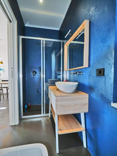 a blue bathroom with a sink and a shower at La Valle Incantata in Lerici