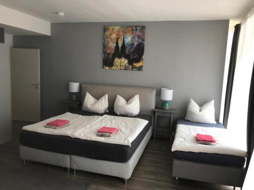 a bedroom with two beds with red towels on them at City Apartment am Dom in Cologne
