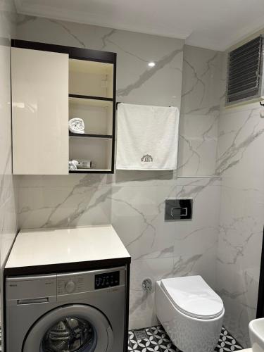 a bathroom with a washing machine and a toilet at Mar Boutique Apartment in Istanbul