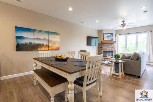 a dining room and living room with a table and chairs at New Build - Walk-In 3BR Condo with Arcade Game - FREE TICKETS INCLUDED - FHG-207 in Branson