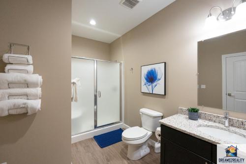 a bathroom with a toilet and a shower and a sink at New Build - Walk-In 3BR Condo with Arcade Game - FREE ATTRACTION TICKETS INCLUDED -- FHG-207 in Branson