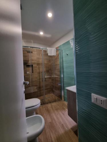 a bathroom with two toilets and a shower at Maison Caravita in Naples