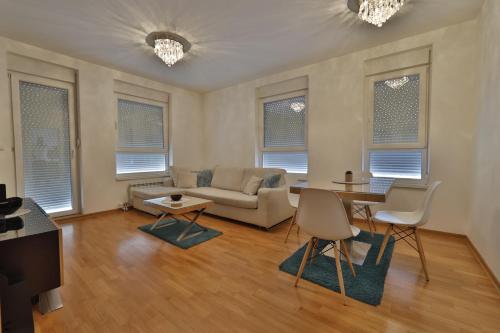a living room with a couch and a table at A blok - One bedroom apartment in Belgrade