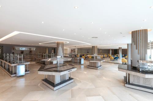 a lobby with tables and chairs in a building at Gewan Resort New Alamein in El Alamein