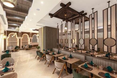 a rendering of a restaurant with tables and chairs at Gewan Resort New Alamein in El Alamein
