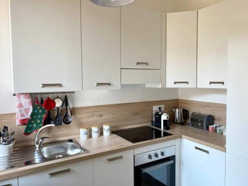 a kitchen with white cabinets and a sink at Casa Eugenia in Varese